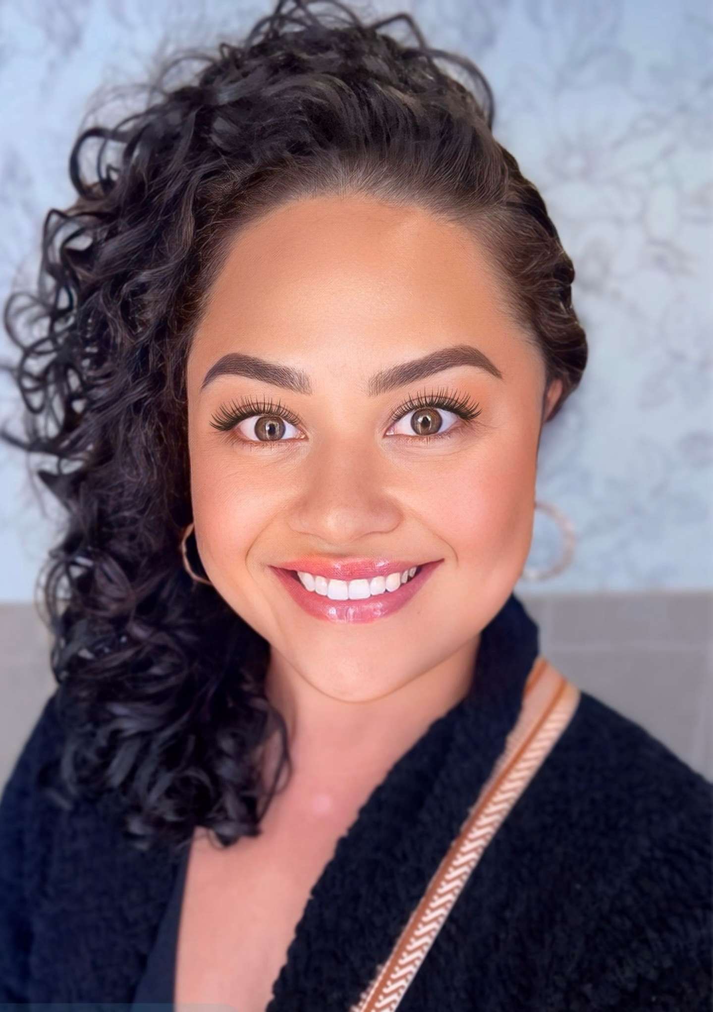 A woman with brown hair smiles at the camera