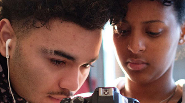 2 students studying a camera's photo