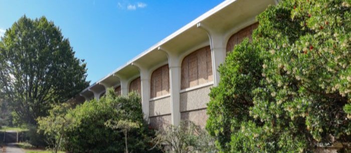 A vacant Fort Lawton building surrounded by trees.