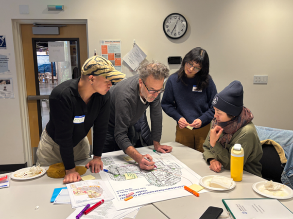 People gathered around a table to map out tree plan
