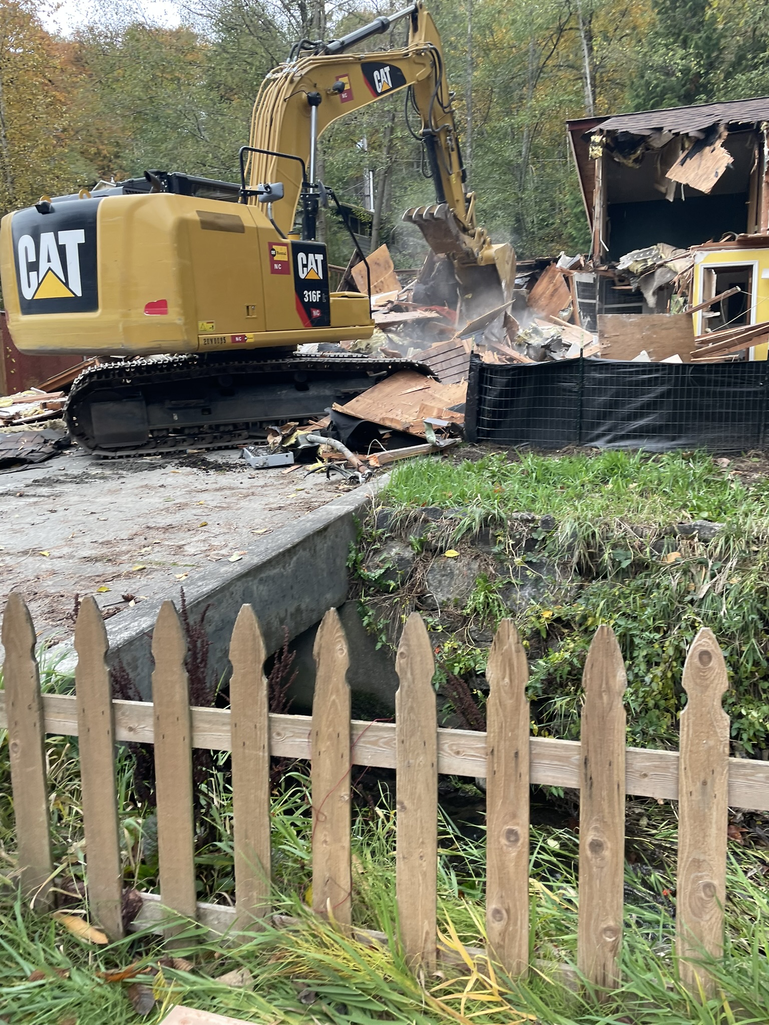 The Seattle Conservation Corps Caterpillar performing demolition work.