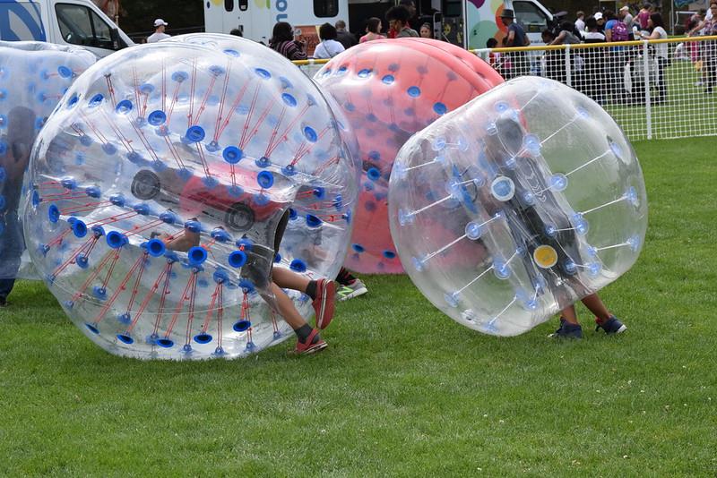 Youth playing inflatable reverse soccer at Big Day of Play