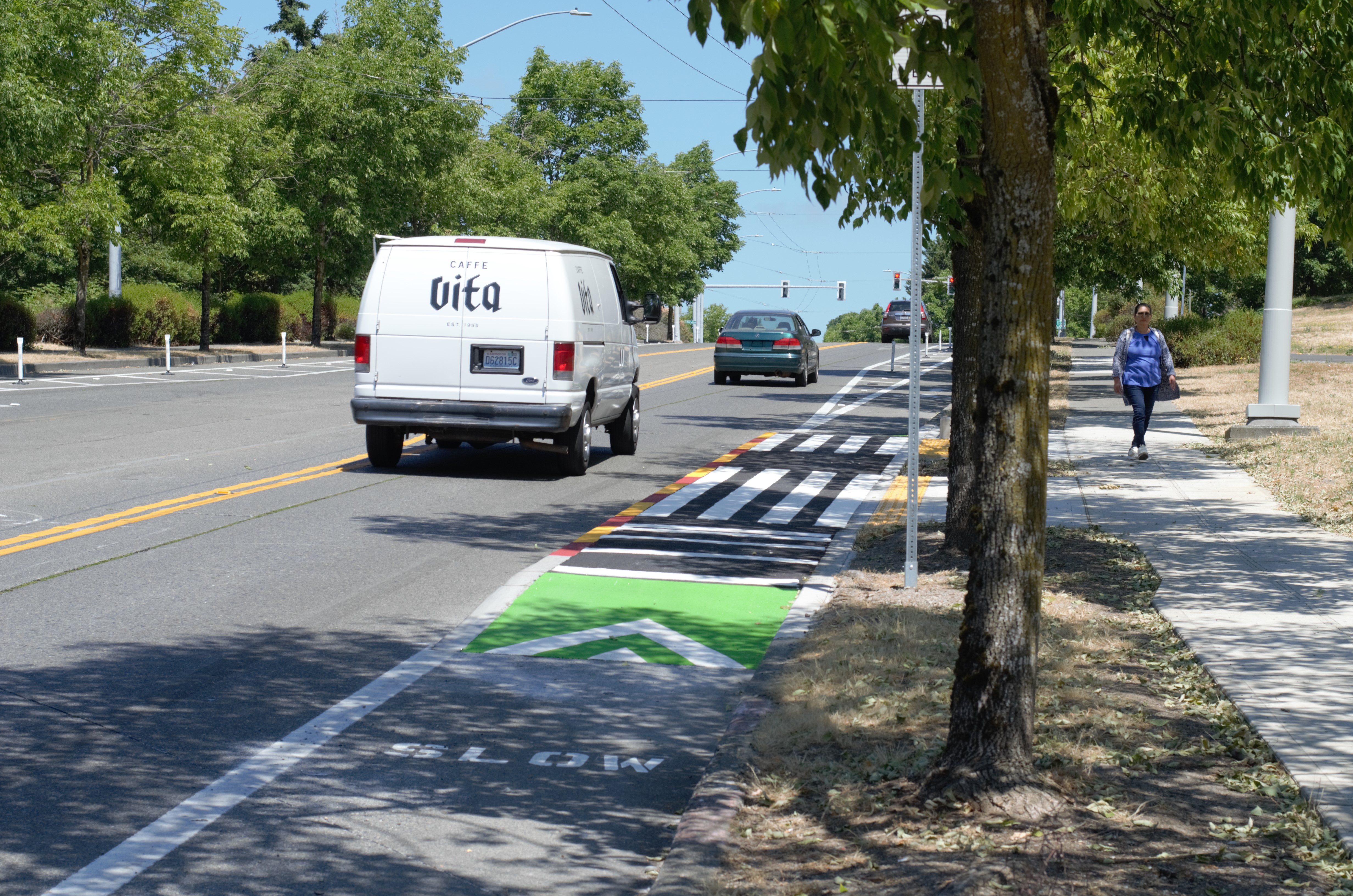 Raised bus islands on both sides of MLK Jr Way S at the S Massachusetts St intersection.