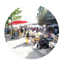 People walking, sitting, and enjoying a people focused street
