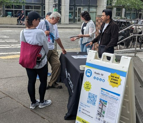 A tabling event with community members learning about the Route 40 project