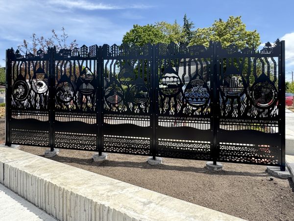 Metal fence with cut out design.