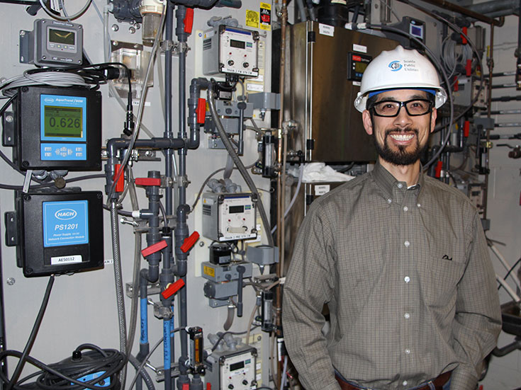 Alex Chen with water system monitoring equipment.