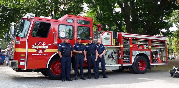 Members of Seattle Fire Department pose in front of a fire truck