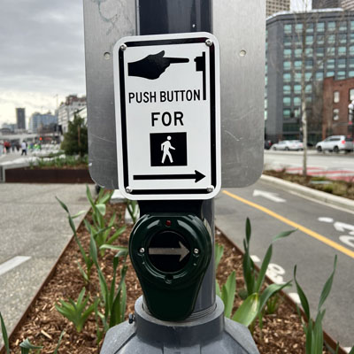 Intersection signals include Accessible Pedestrian Signal (APS) push buttons with audible messaging letting people know when to cross.