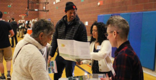 a small group of people looking at a paper document together