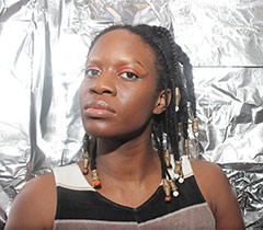 Le'Ecia is Black with shoulder-length braids.