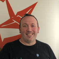 Pinky is a white man with short hair and a goatee. 