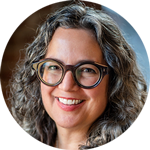 Tina has long, wavy hair and cool glasses.