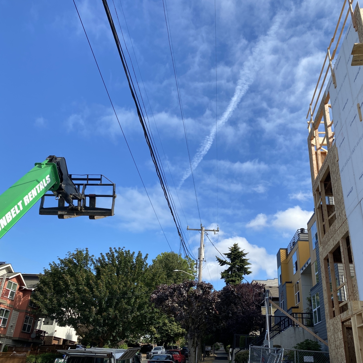 Photo of building construction near powerlines.