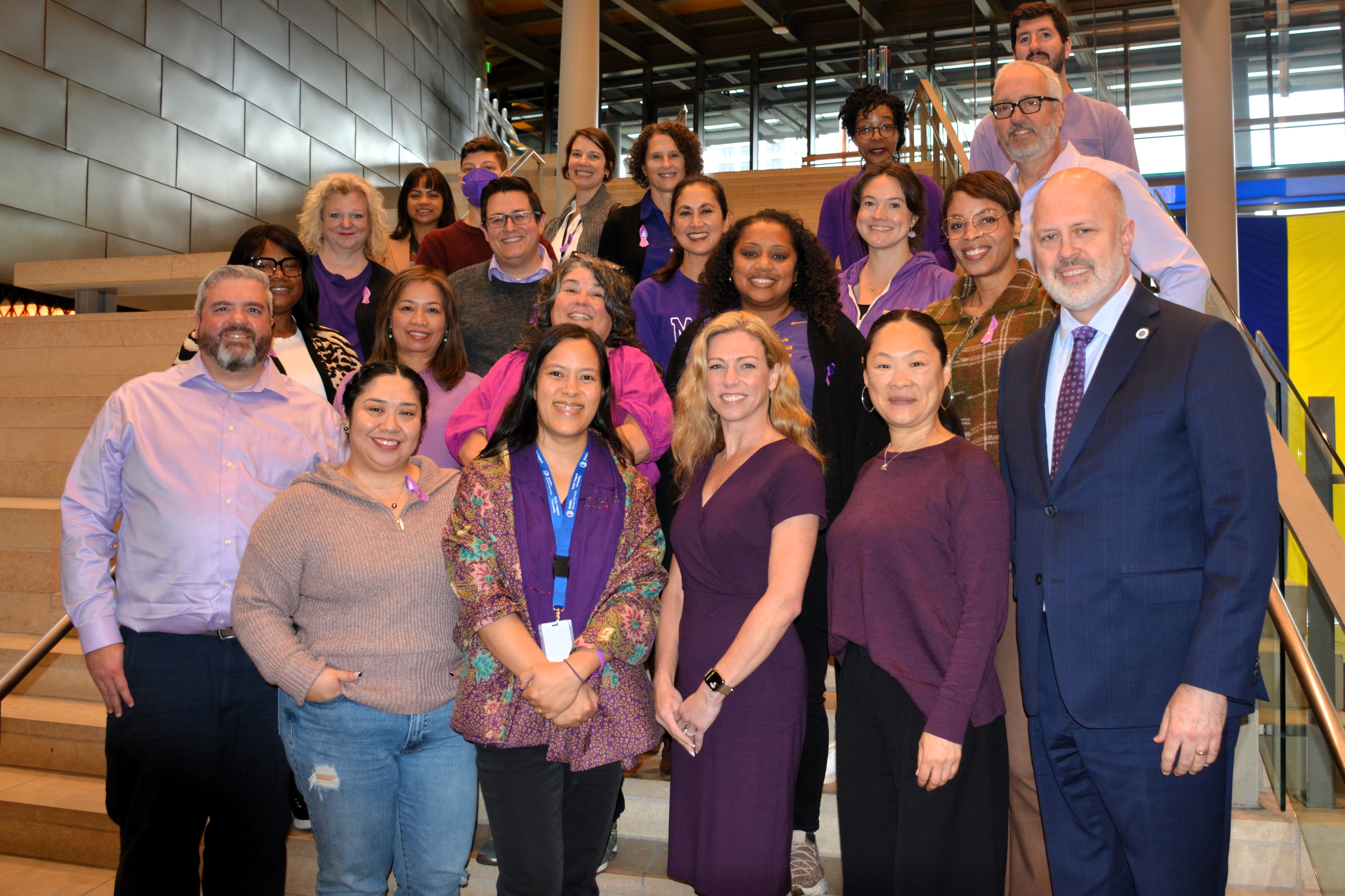 City staff gather for a photo dressed in purple for Domestic Violence Awareness Month 2024
