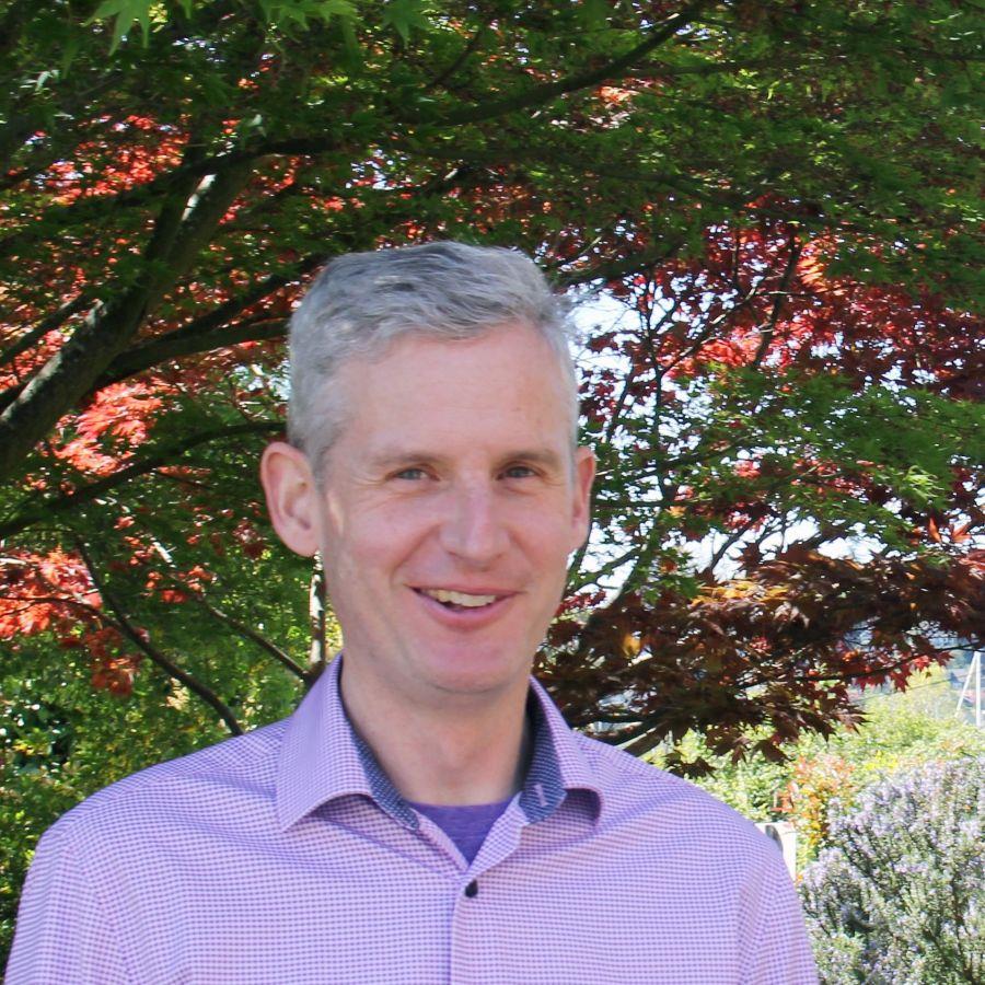 a picture of a man in front of a tree