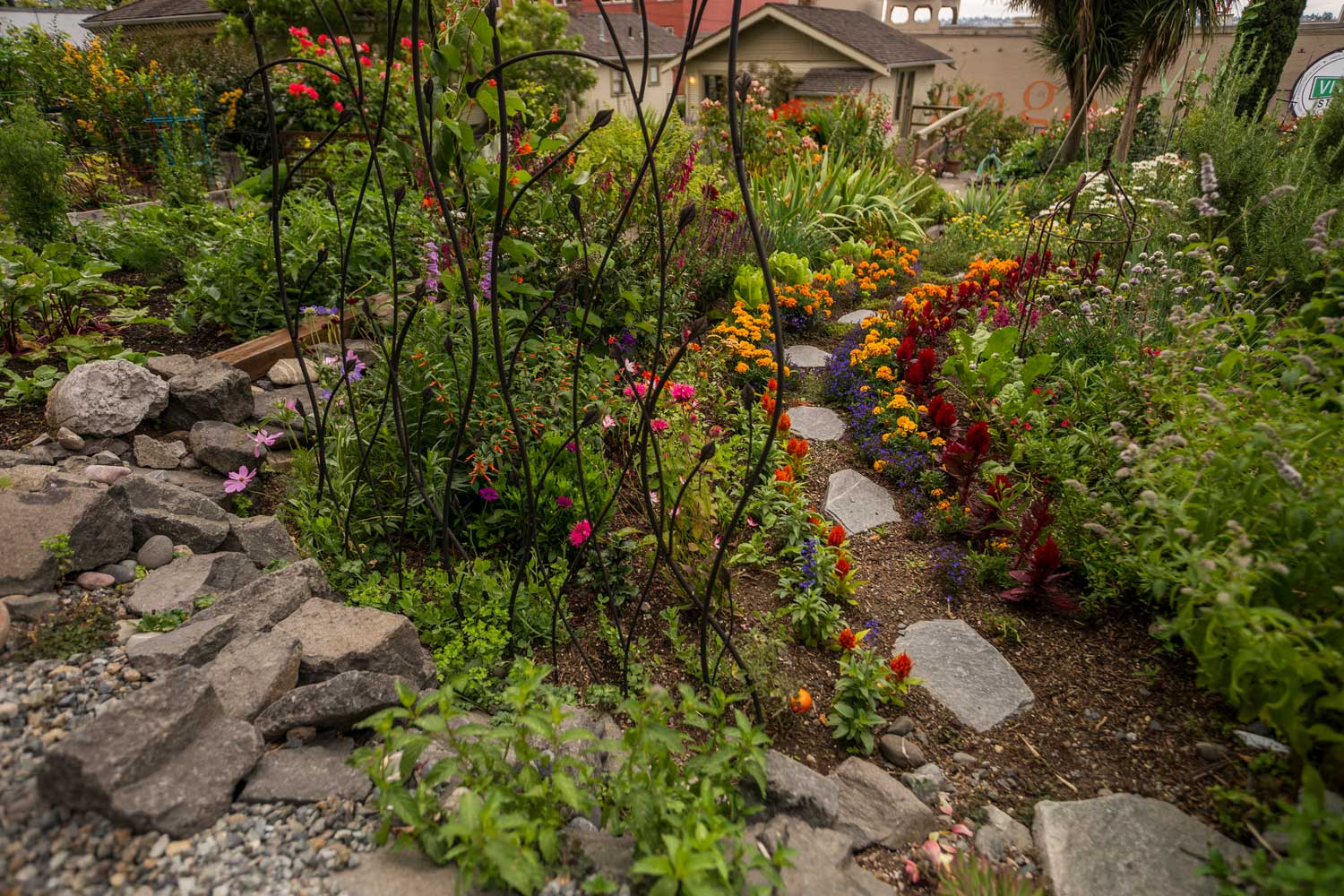 Belltown Cottage Park sculpture in flower bed - Photo by TIA International Photography