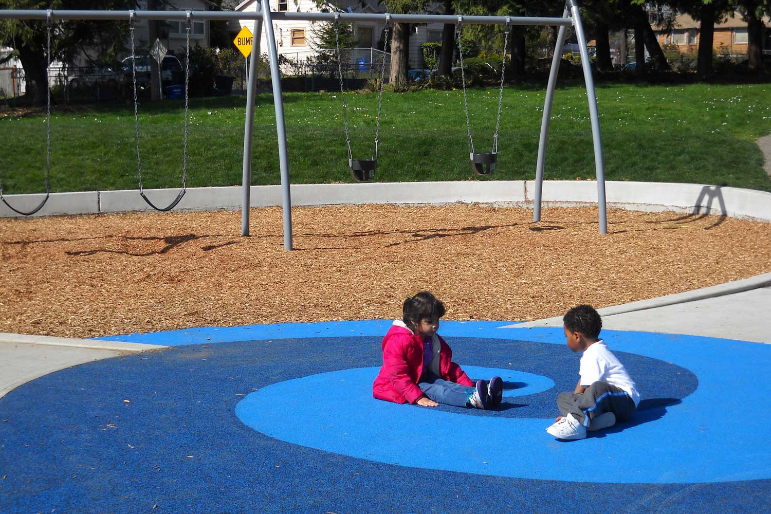 Children seated at Brighton Playfield - photo by Laurel Mercury