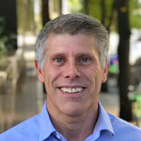 Photo of Darrell Bulmer, smiling and standing outside. 