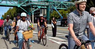 People on bikes at the opening of the Alaskan Way Safety Project. 