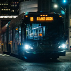 A C-Line bus running in downtown Seattle at night