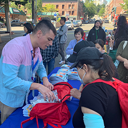 People putting together an emergency preparedness backpack