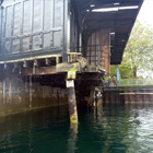 Close up of the docks wooden piles which are leaning and damaged